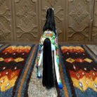 Back view showcasing the long black string tail and vibrant artistry.