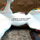 Artist's signature painted on the underbelly of the horse.
