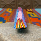 Oaxacan roadrunner wood carving by Julia Calvo Olivera with a long yellow beak, swept-back crest, and multicolored geometric patterns.