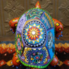 Floral motifs on the orange wood shell, with fine yellow and blue accents.