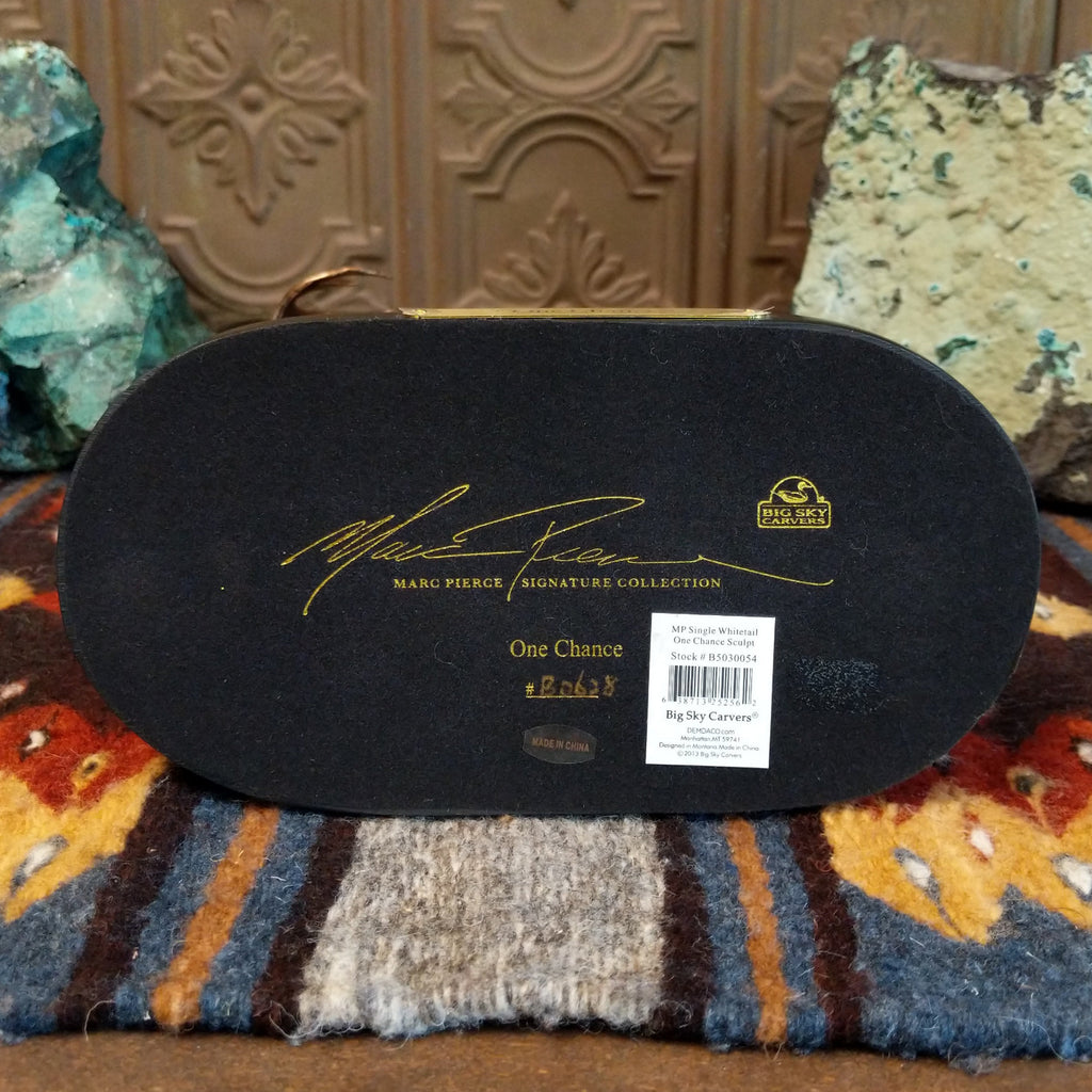 The bottom of the base showcases the artist's signature.