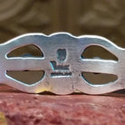 Close-up of artisan's stamped signature.