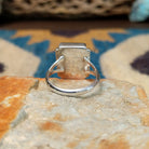 Handcrafted sterling silver orange spiny oyster and manmade opal ring by Sheryl Martinez, featuring a rectangular inlay with shimmering opal accents; underside view.