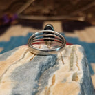 Sterling silver ring with orange spiny oyster shell set in an oval bezel and layered band.