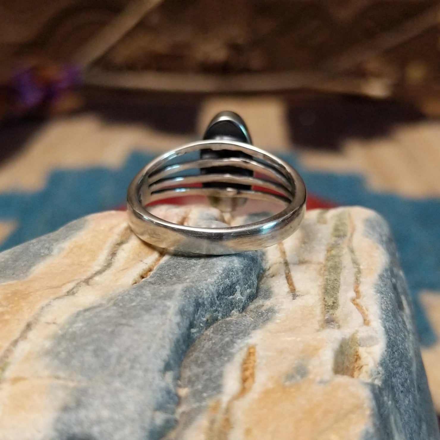 Sterling silver ring with orange spiny oyster shell set in an oval bezel and layered band.
