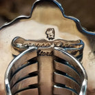 Close-up of the artisan's stamped signature.