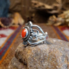 Sterling silver ring with ornate silver work and coral set in the round bezel.