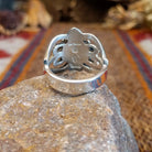 Sterling silver ring with ornate silver work and coral set in the round bezel.