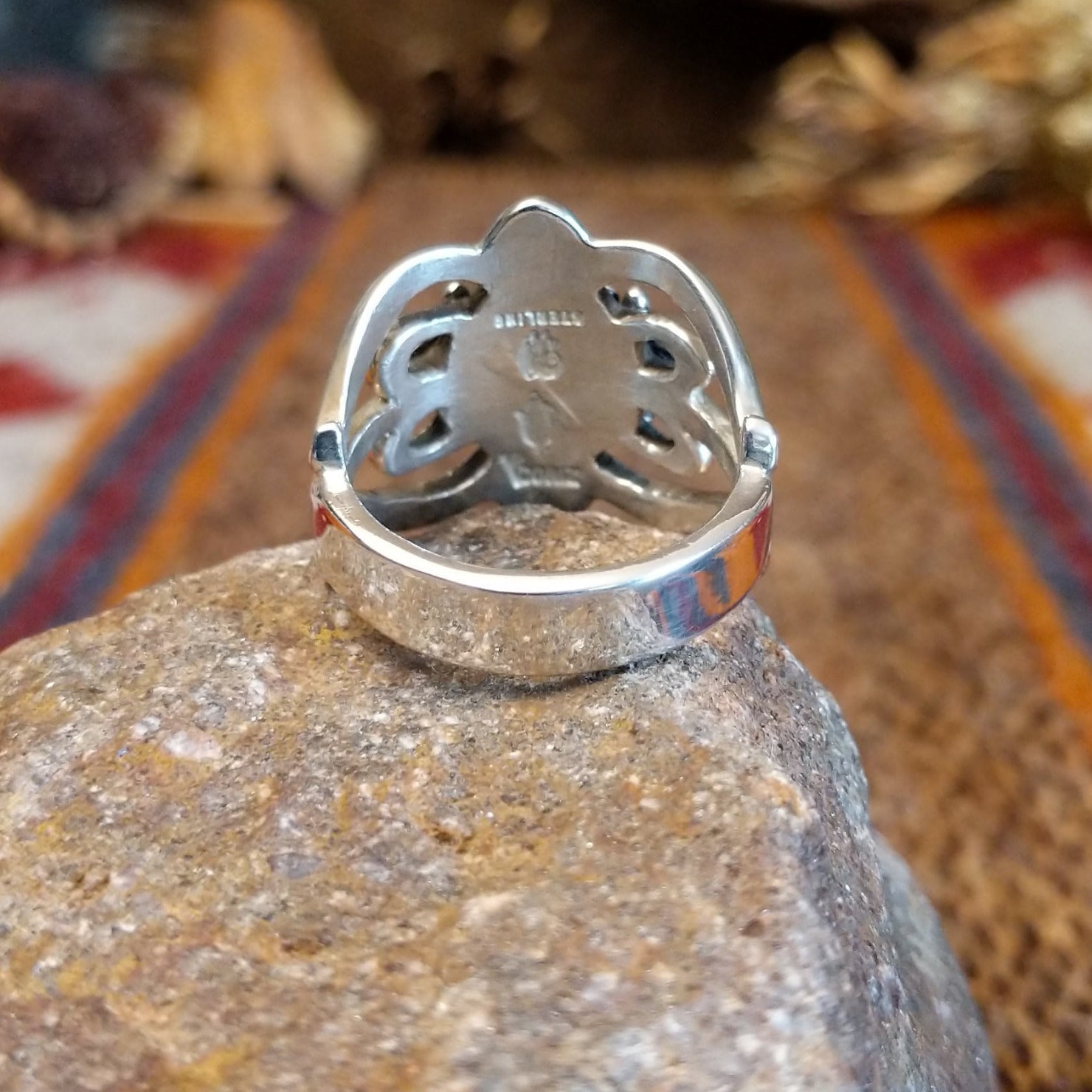Sterling silver ring with ornate silver work and coral set in the round bezel.