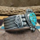 Kingman turquoise cuff by Michael Calladitto, featuring a blue Kingman turquoise stone with a natural brown matrix set in a handcrafted sterling silver cuff; side view.