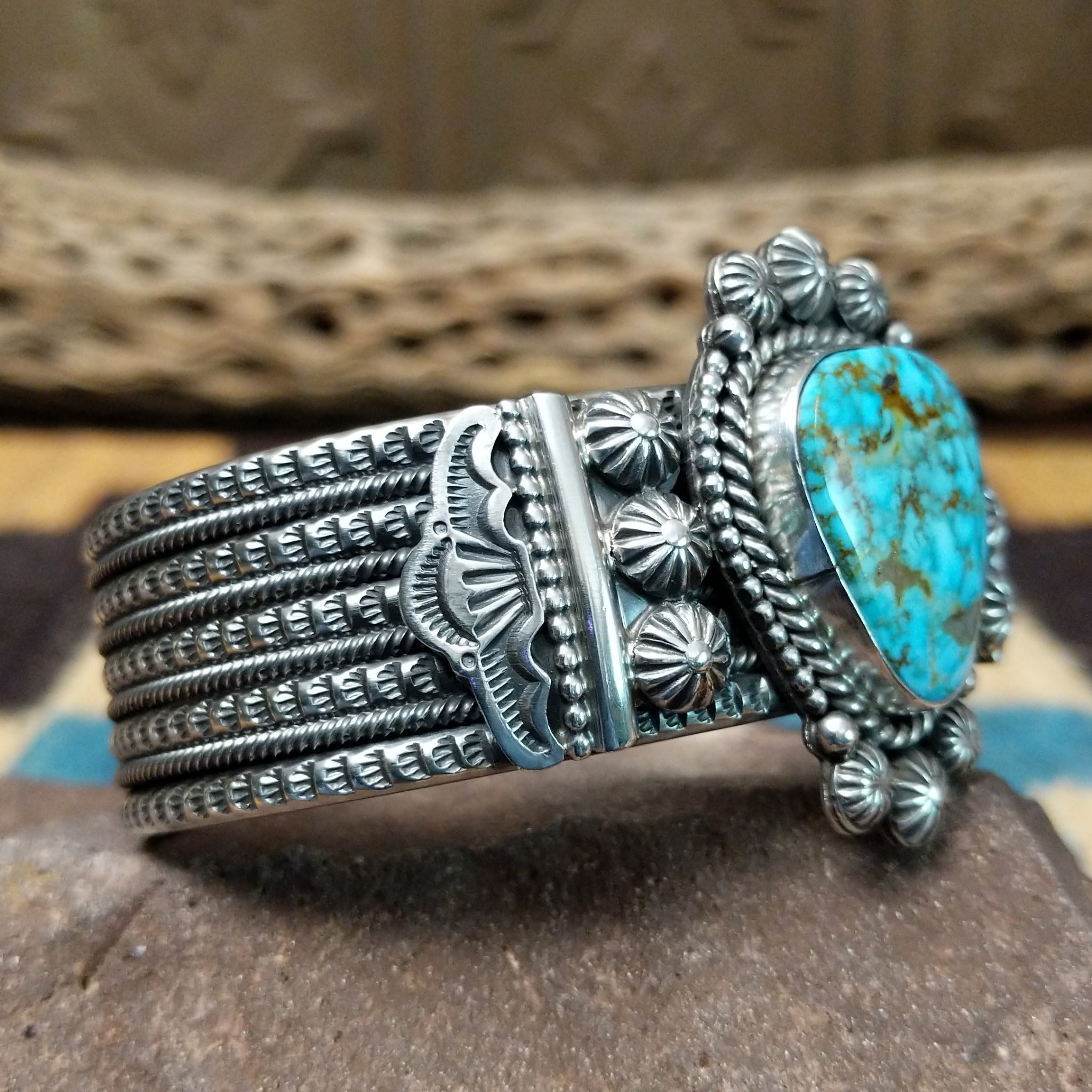 Kingman turquoise cuff by Michael Calladitto, featuring a blue Kingman turquoise stone with a natural brown matrix set in a handcrafted sterling silver cuff; side view.