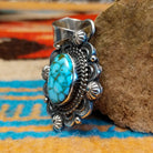 Sterling silver pendant with Kingman turquoise set in the oval bezel, framed by the ornate setting with twisted rope and dotted accents.