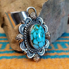 Sterling silver pendant with Kingman turquoise set in the oval bezel, framed by the ornate setting with twisted rope and dotted accents.