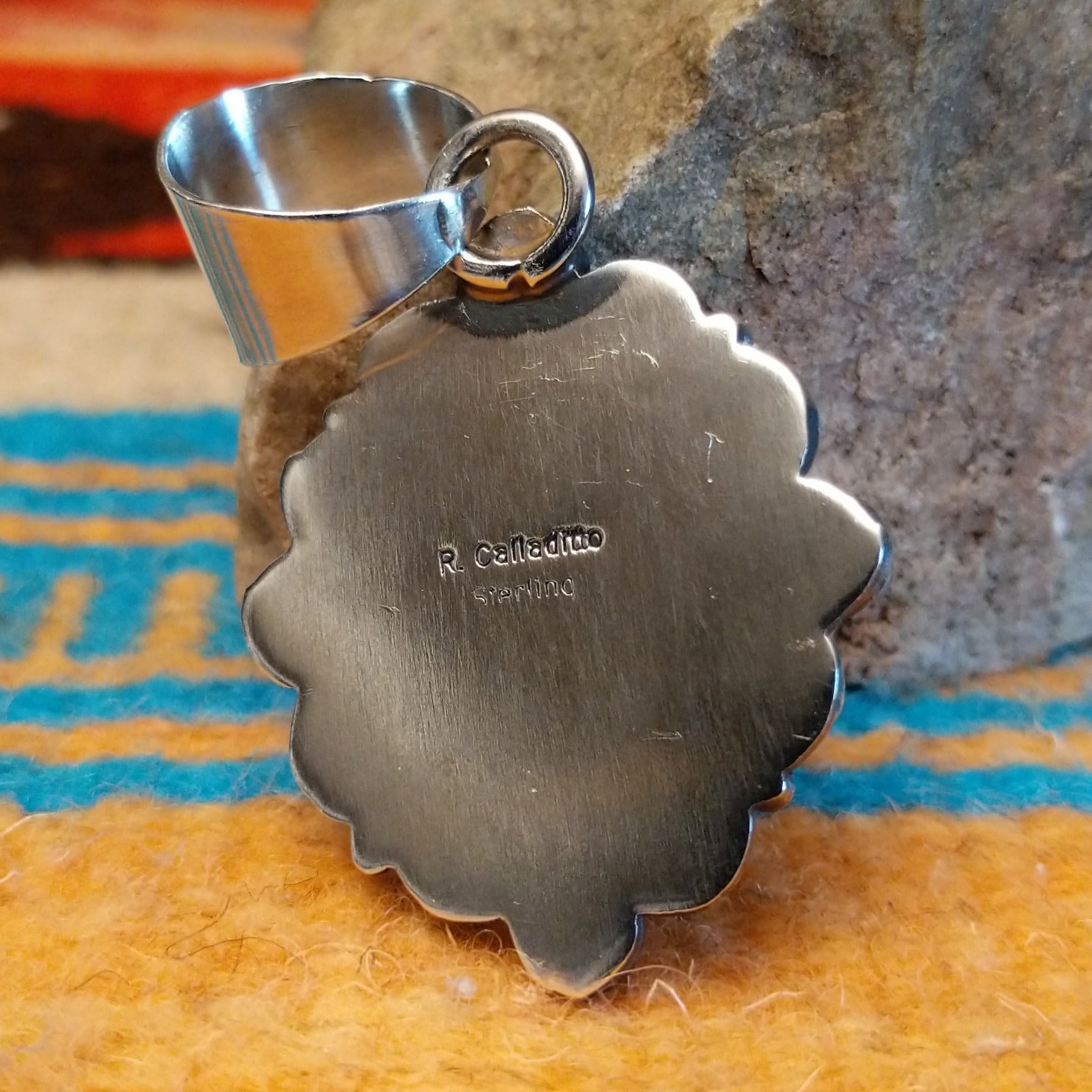 Close-up of the artisan's stamped signature.