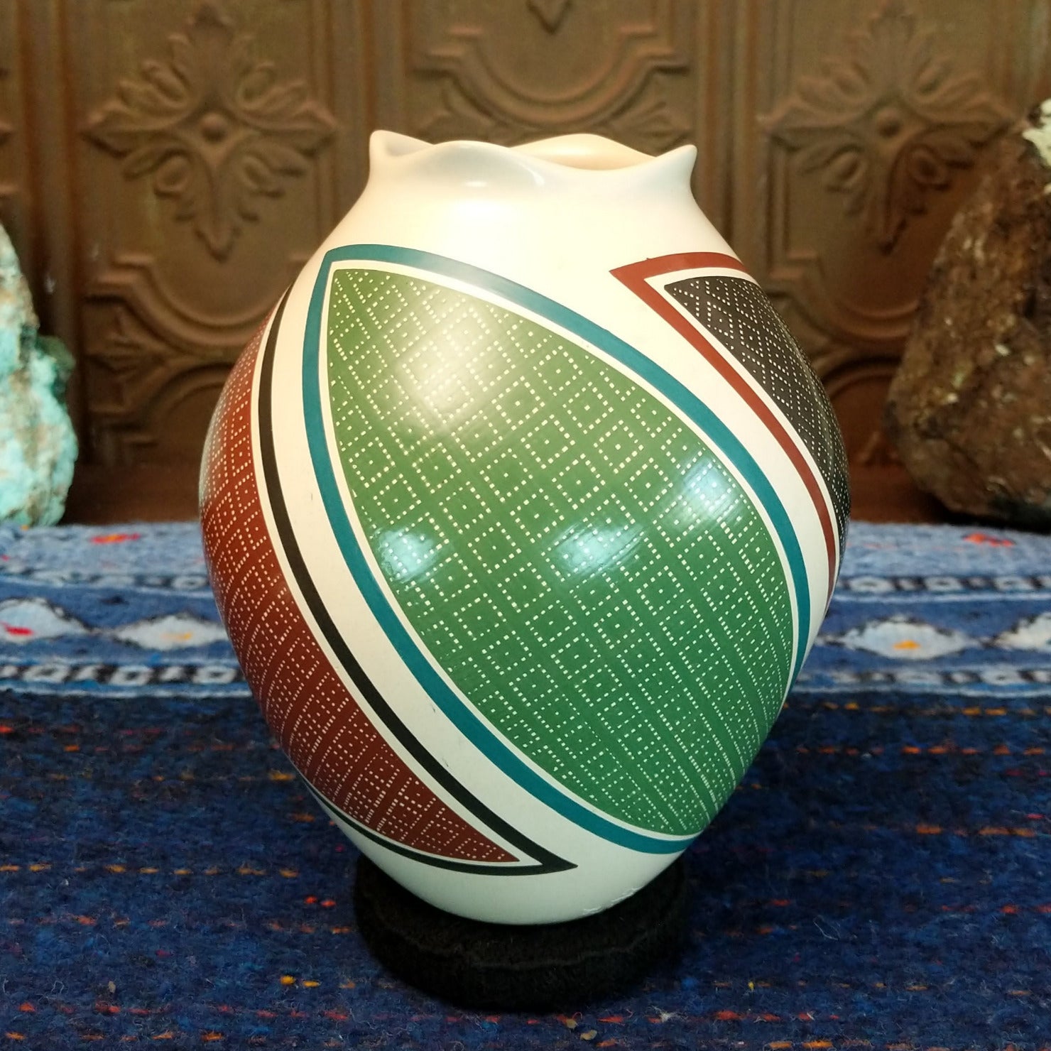 White clay base with multicolored geometric designs.