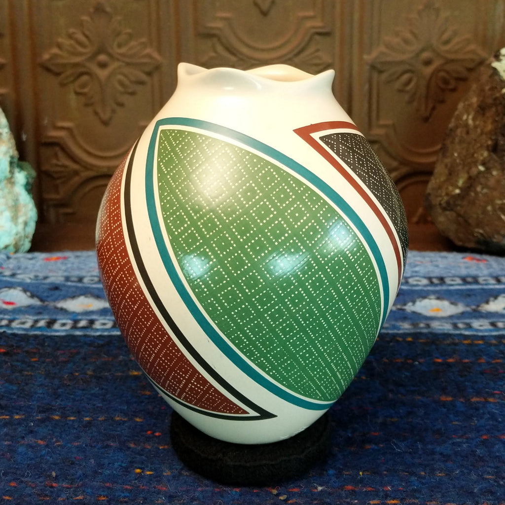 White clay base with multicolored geometric designs.