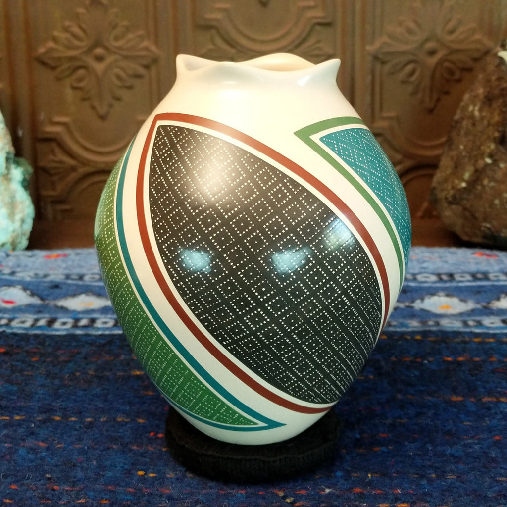 White clay base with multicolored geometric designs.