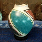 White clay base with multicolored geometric designs.