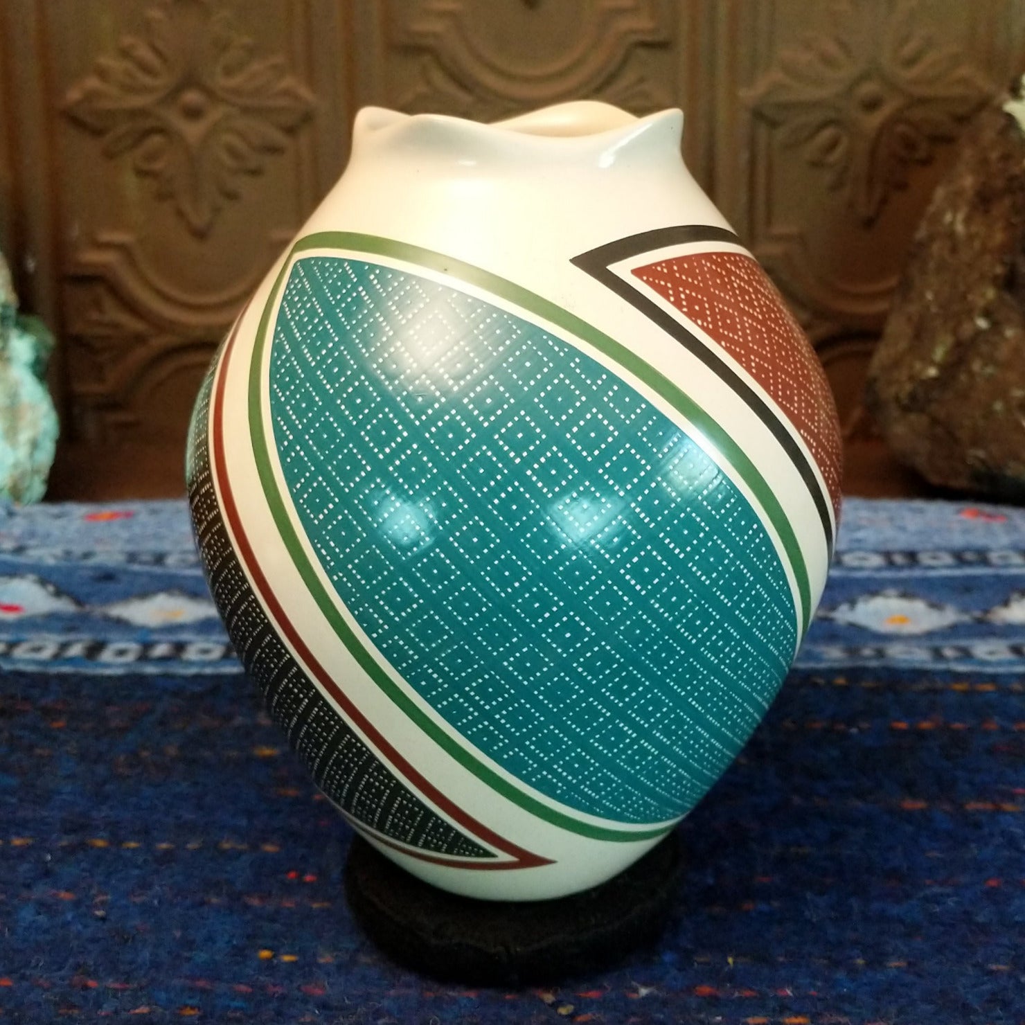 White clay base with multicolored geometric designs.