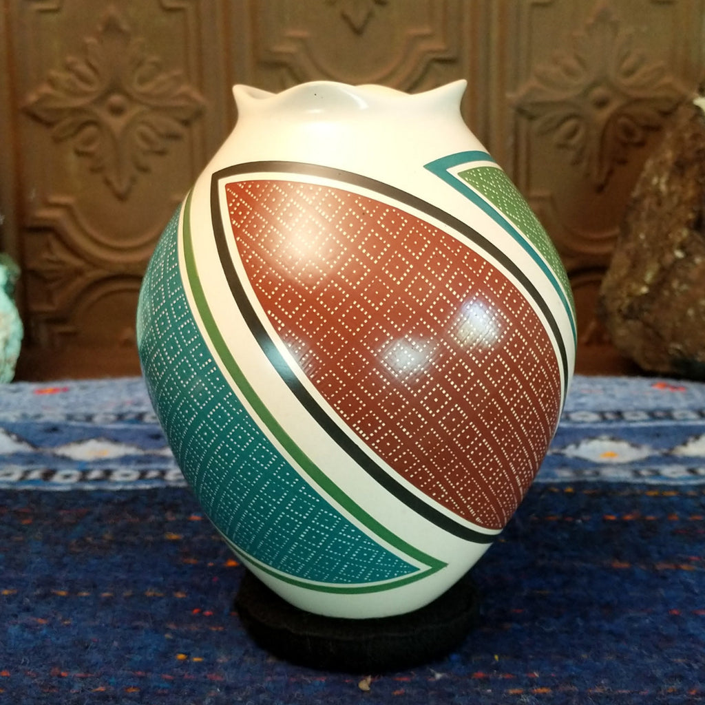 White clay base with multicolored geometric designs.