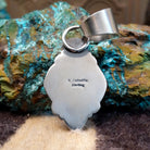 Close-up of the artisan's stamped signature.
