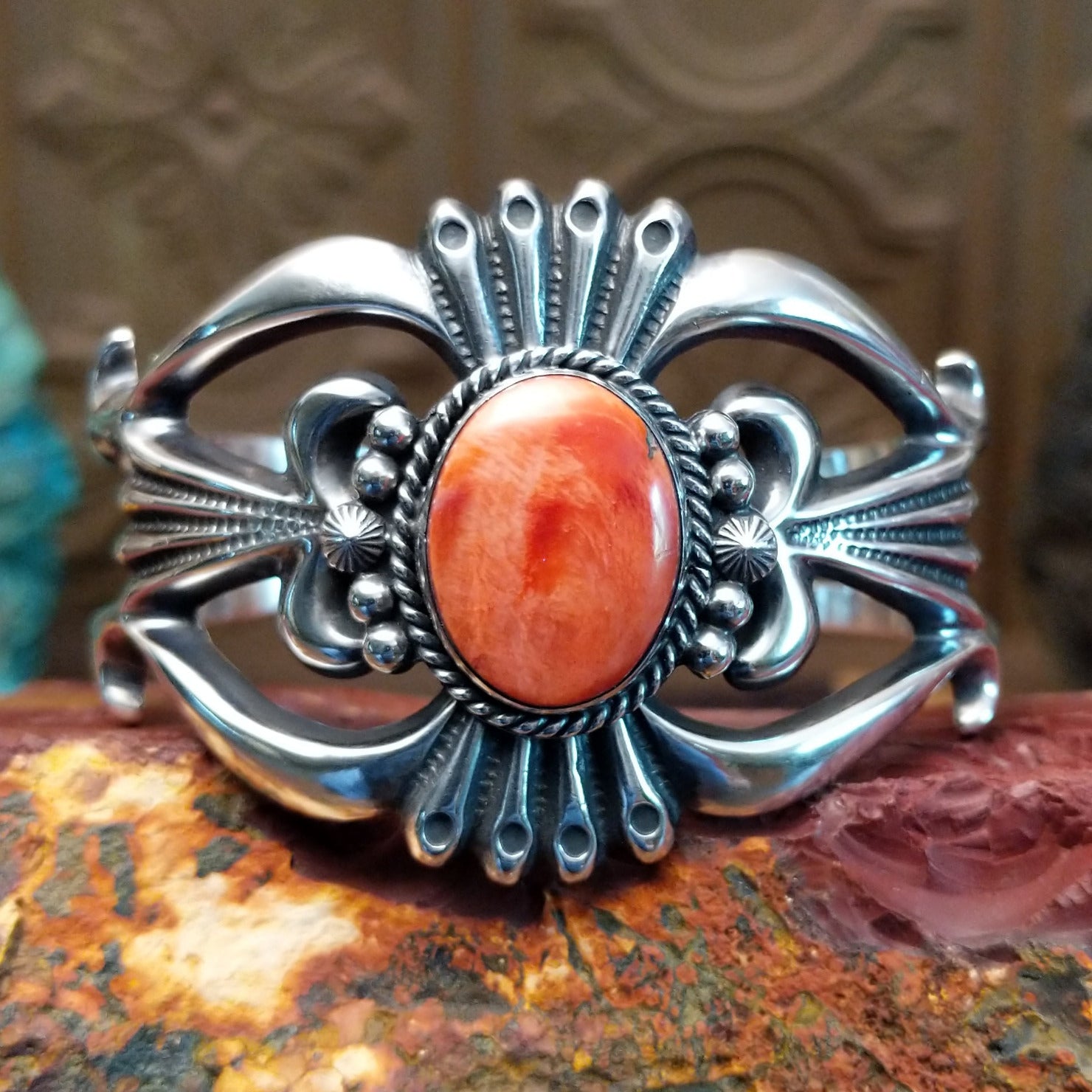 Sterling silver cuff featuring red spiny oyster shell set in the oval bezel.