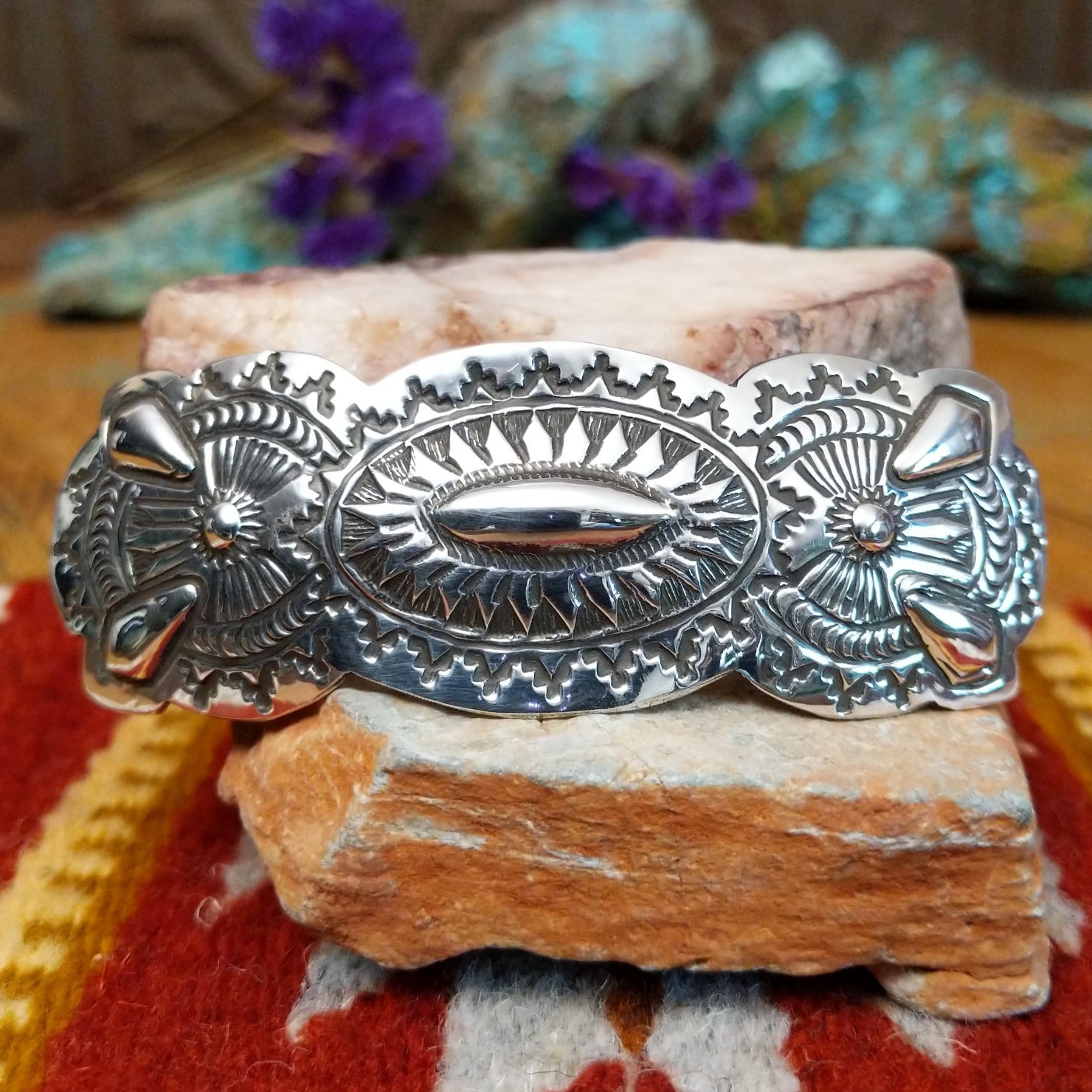 Sterling silver barrette by Harold Tom with ornate stamped silverwork and raised oval center.