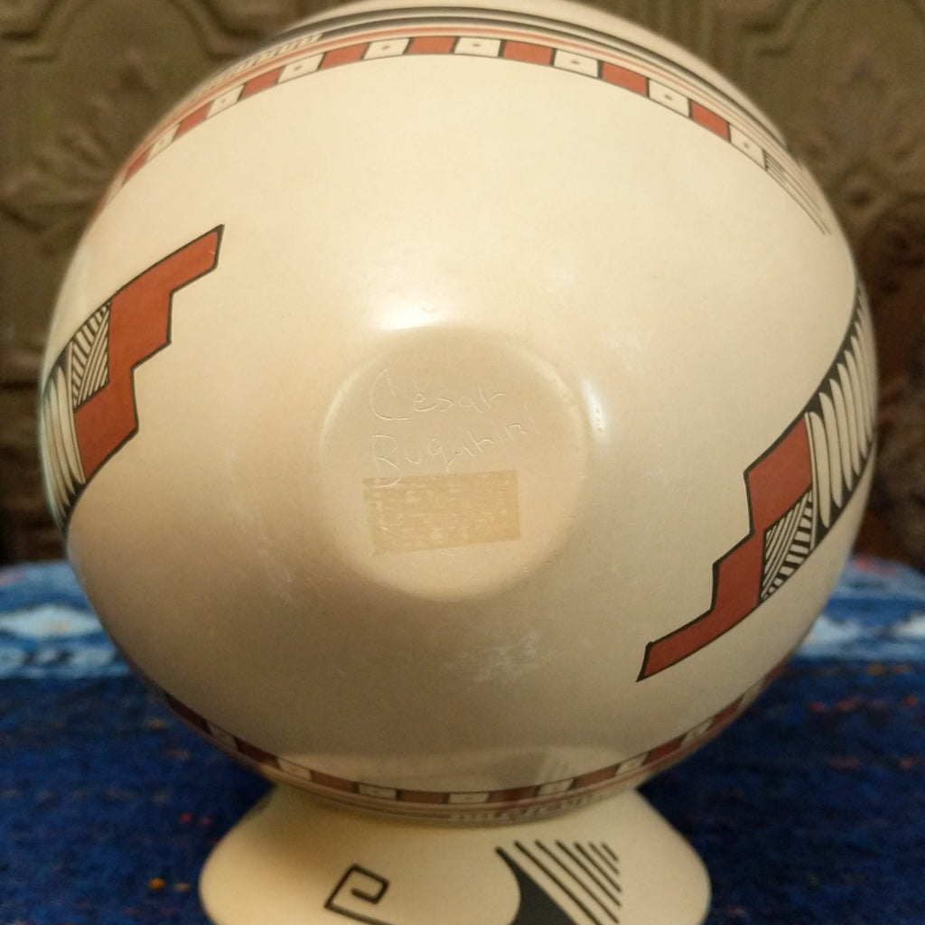 The base of the pottery is etched with the artist's signature.