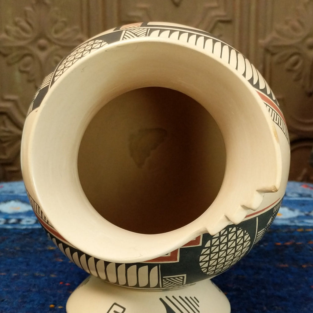 The top features the hollow inside of the pot with smooth clay and stepped lip.
