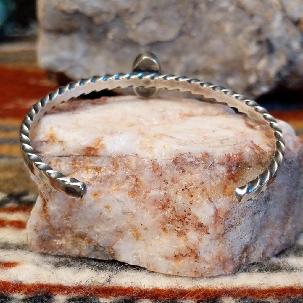 Brushed sterling silver band of the cuff.