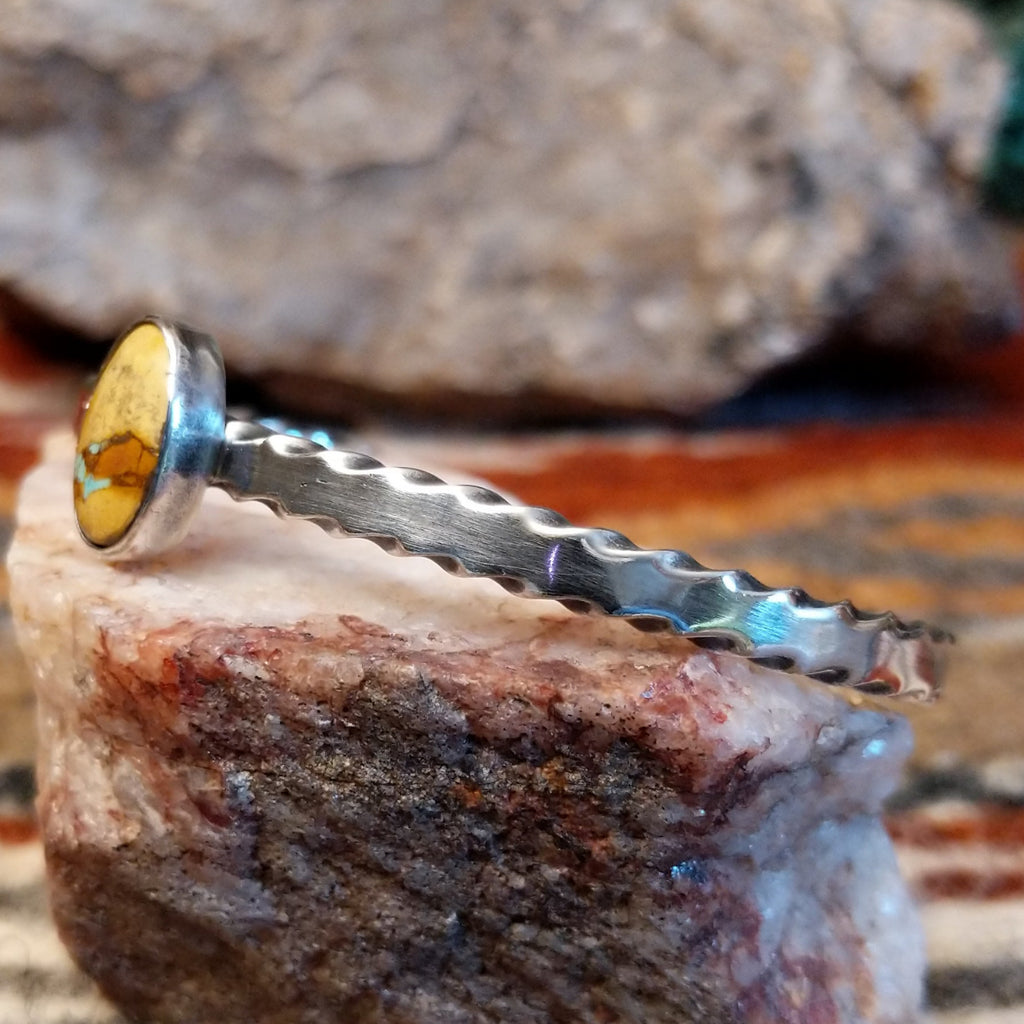 Oval boulder turquoise set in the bezel with a brushed sterling silver band of the cuff.