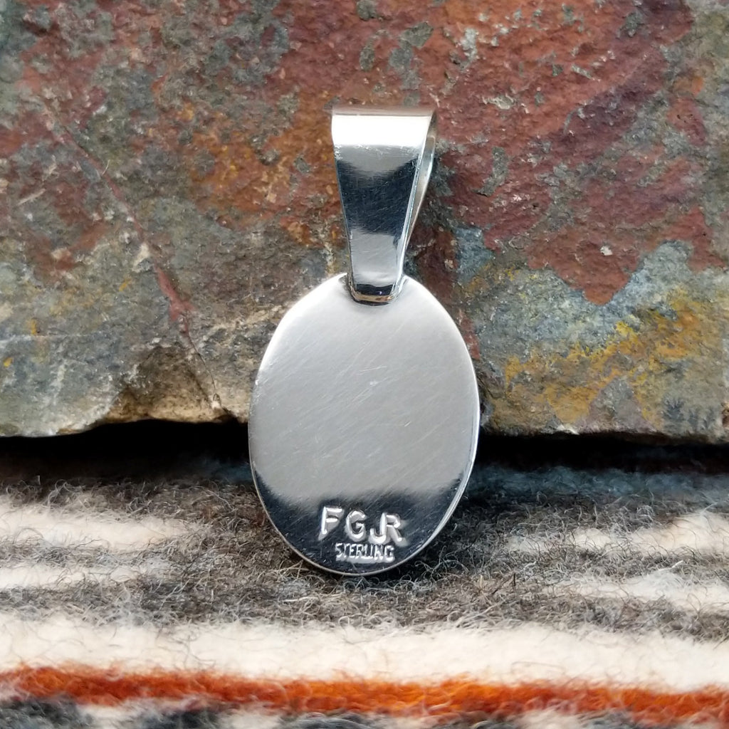 The back features the artisan's initials.