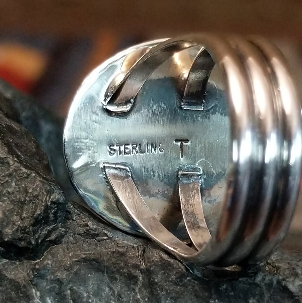 A close-up view of the stamped initials and sterling silver authentication. 