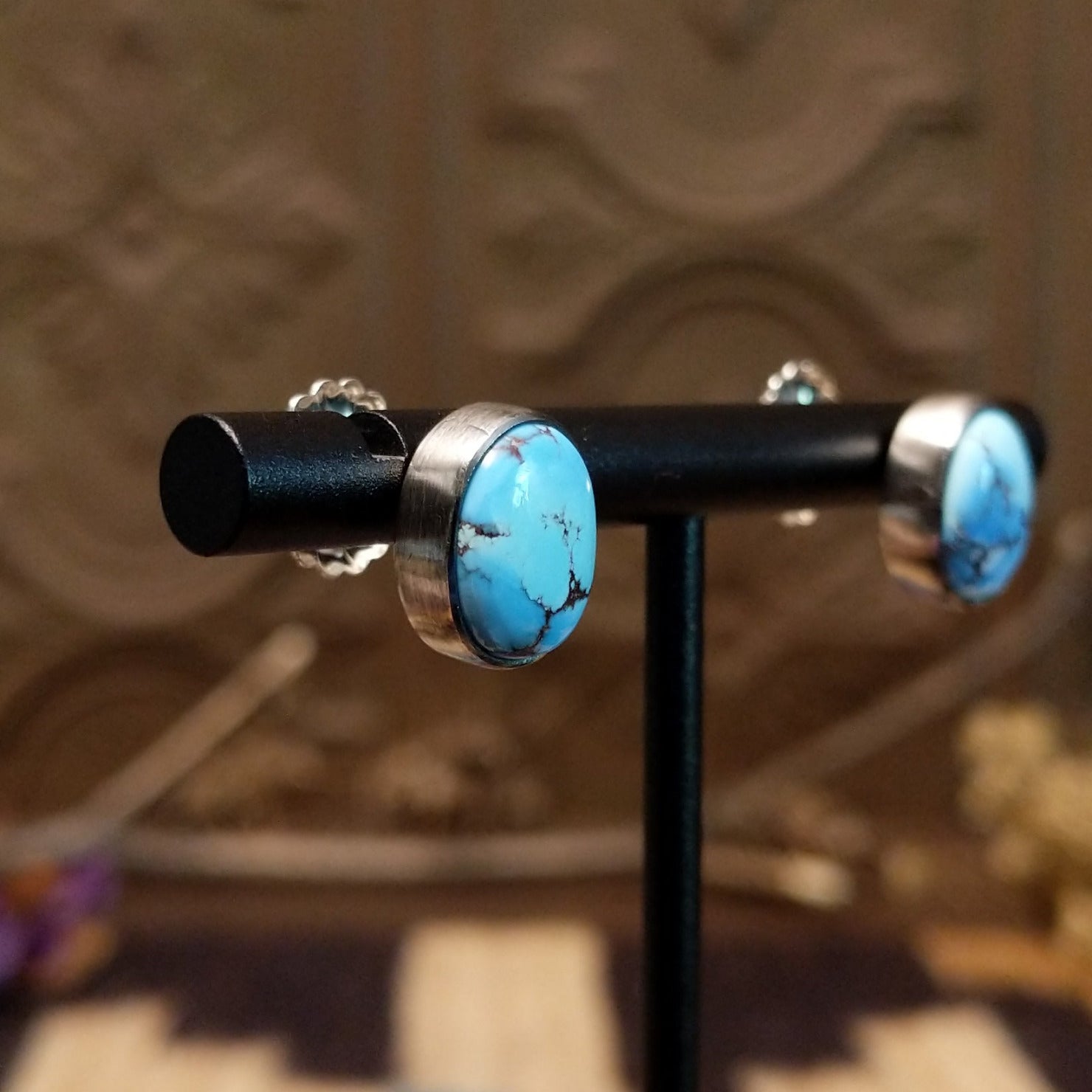 Sterling silver earrings with turquoise set in oval bezels.