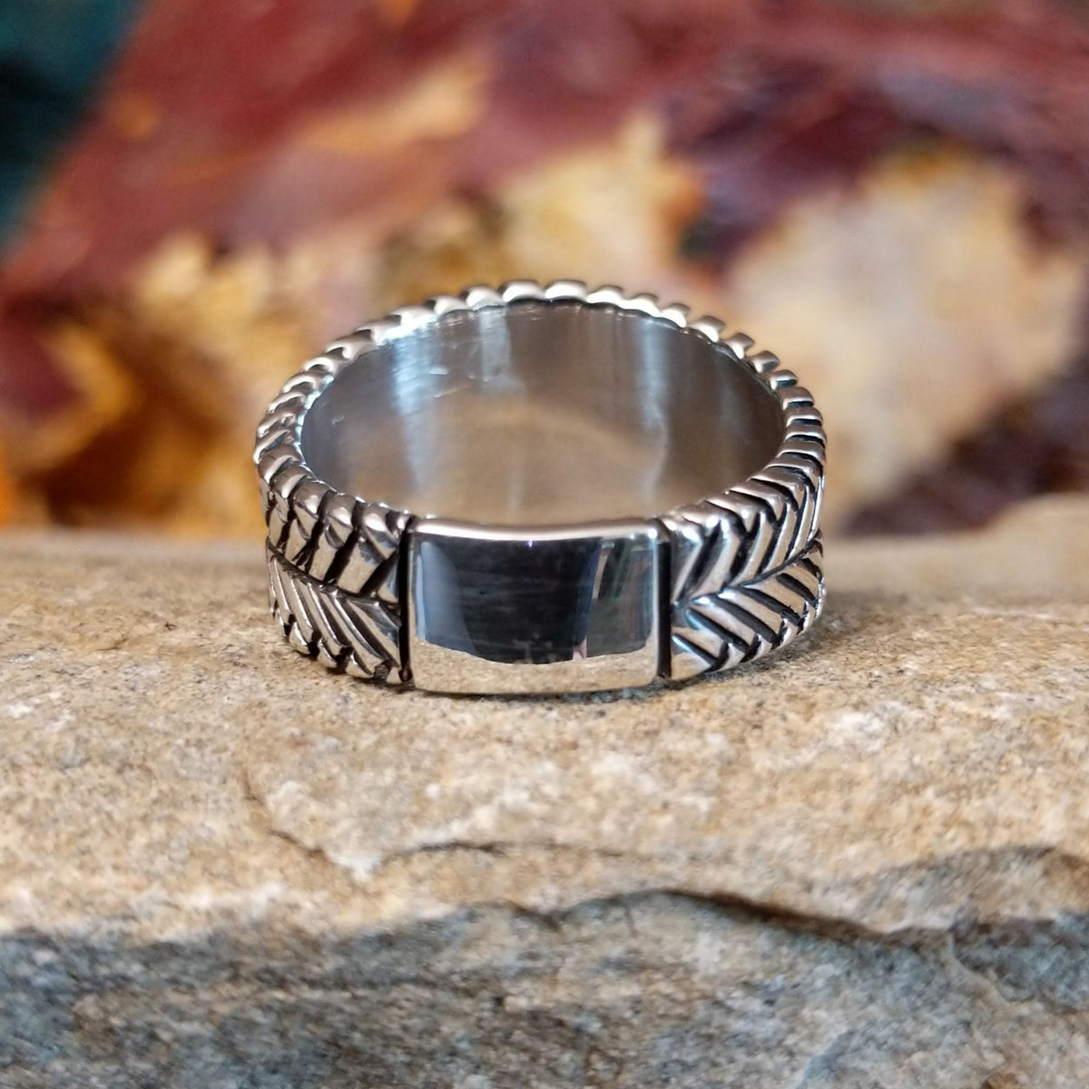 The band of the ring is in a dual braided sterling silver design.
