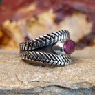 Oval purple spiny oyster shell set in a silver bezel with a braided sterling silver band.