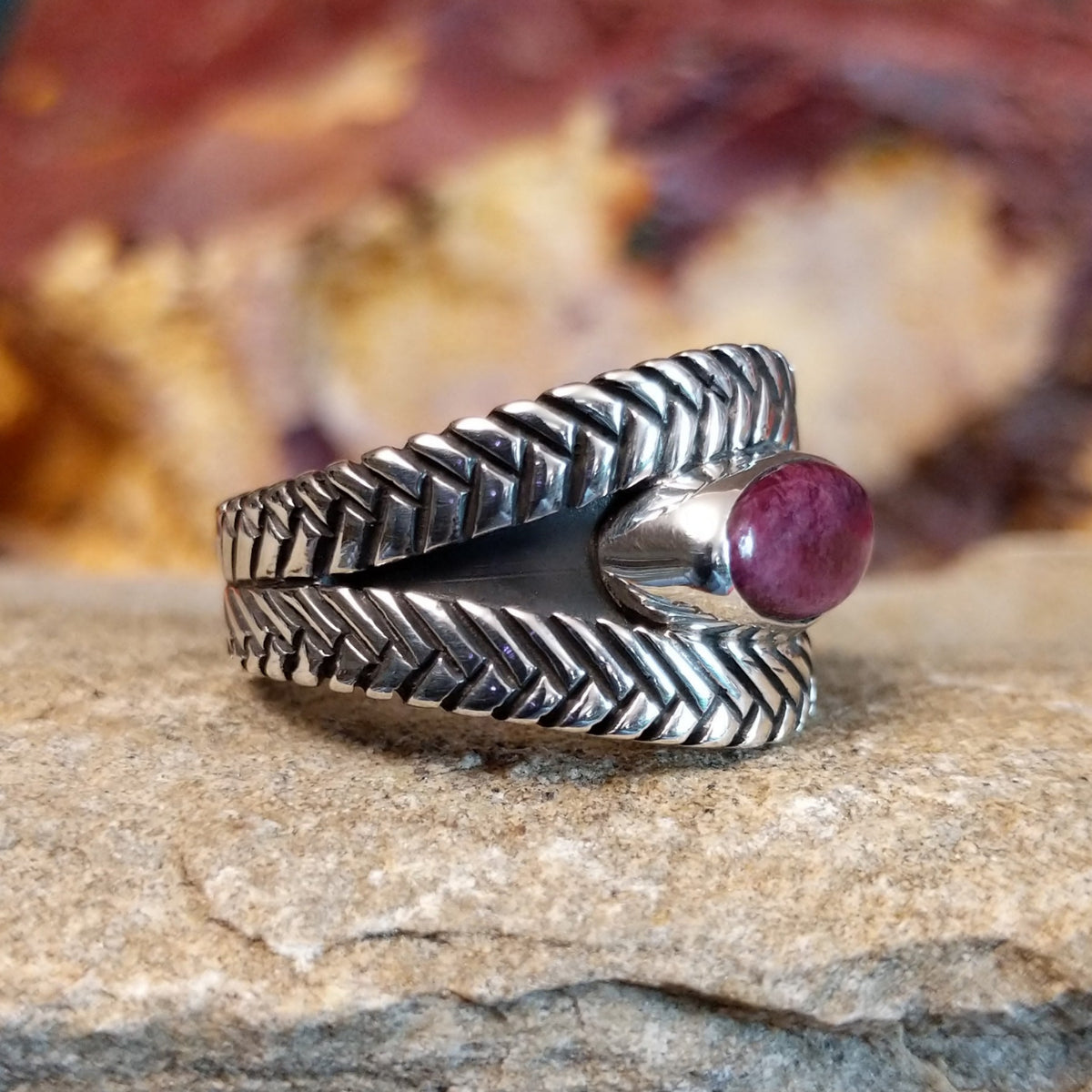Oval purple spiny oyster shell set in a silver bezel with a braided sterling silver band.