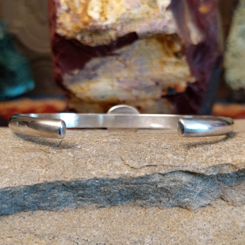 The opening of the cuff shows it's polished silver band.