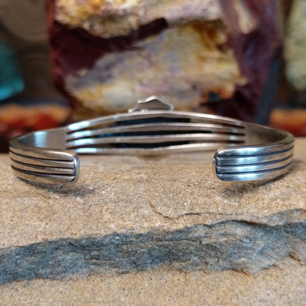 The back of the cuff showcases the polished silver band.
