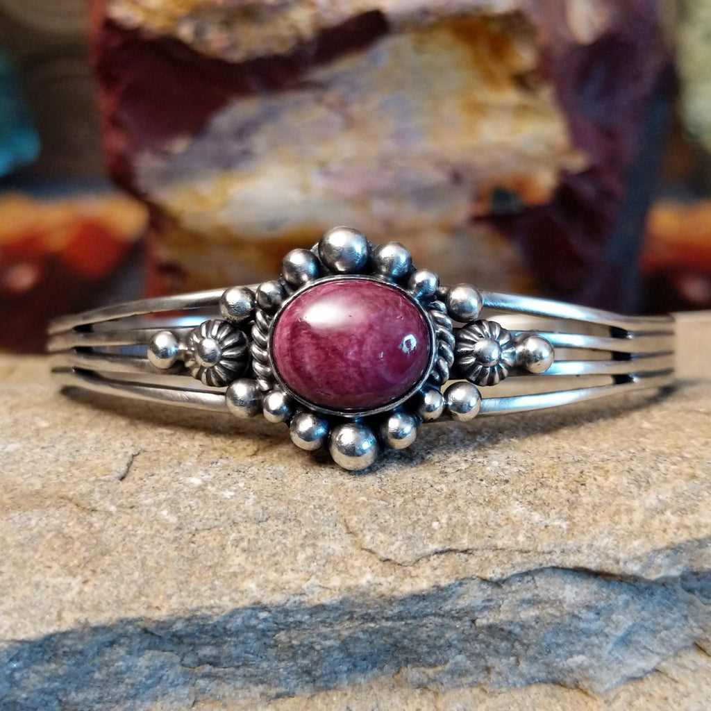 An oval purple spiny oyster shell cuff shines in sterling silver with beaded and twisted rope accents.