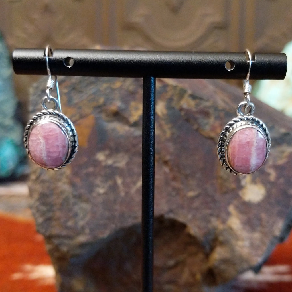 Rhodochrosite framed by twisted rope bezels on dangle earrings.
