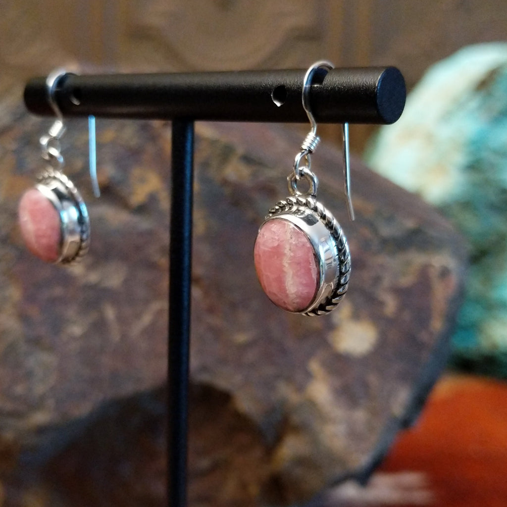 Rhodochrosite framed by twisted rope bezels on dangle earrings.