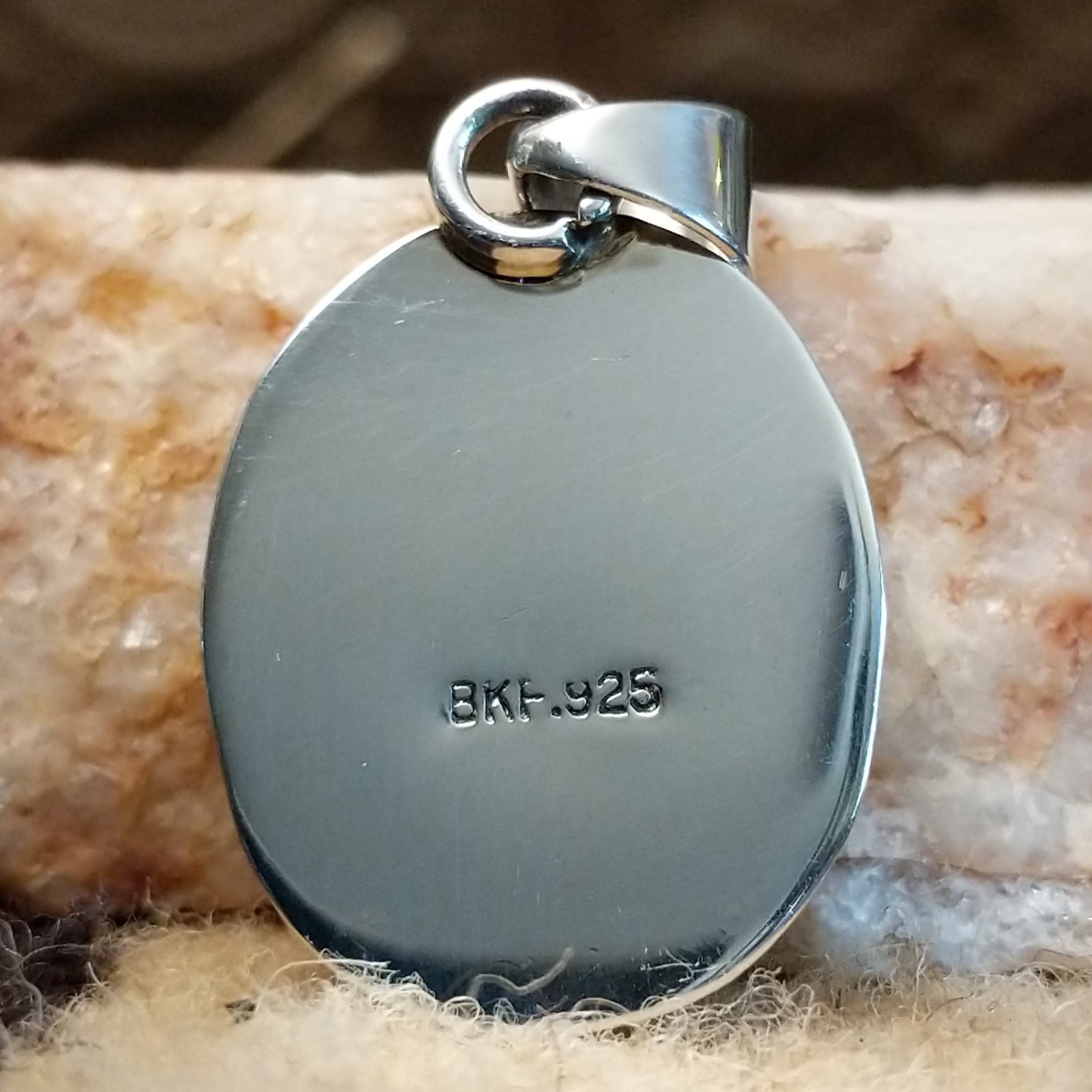 Close-up of the artisan's stamped signature.