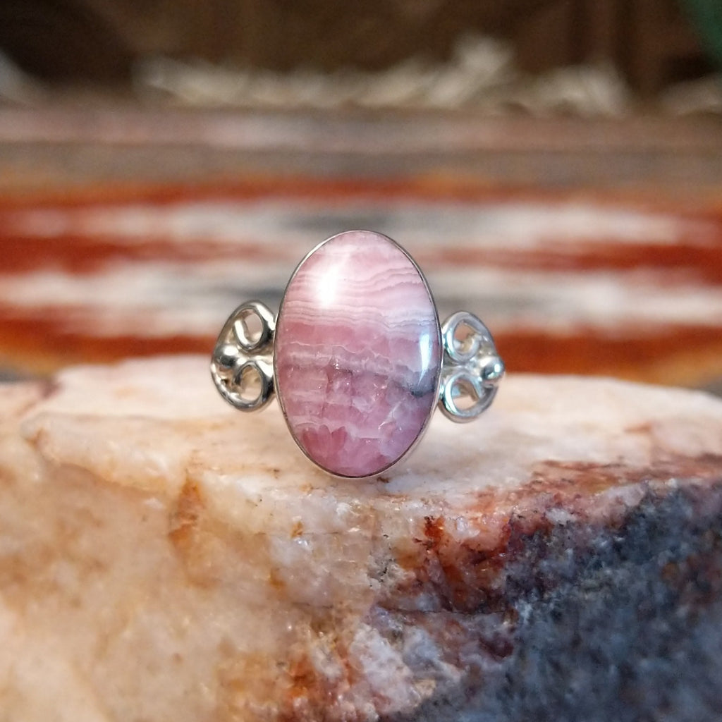 Sterling silver ring with ornate band and rhodochrosite set in the bezel.