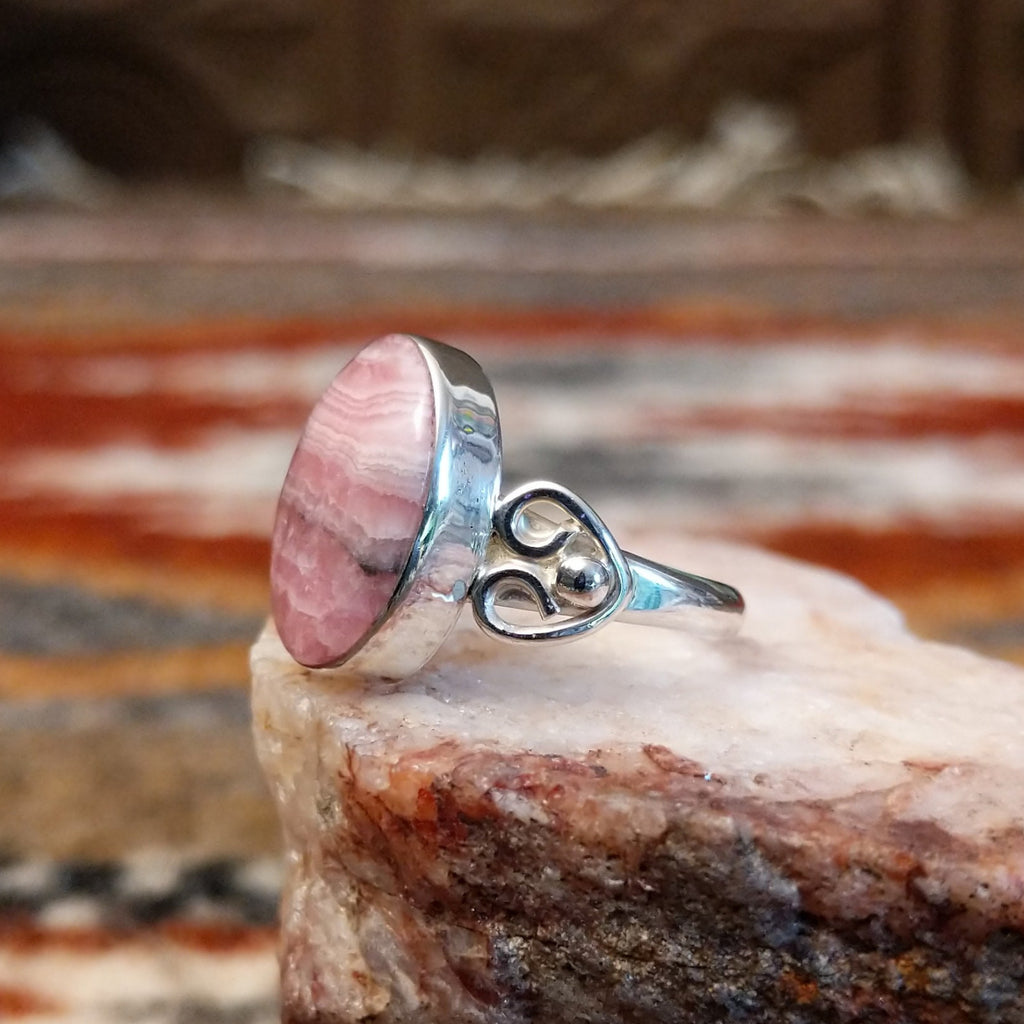 Sterling silver ring with ornate band and rhodochrosite set in the bezel.