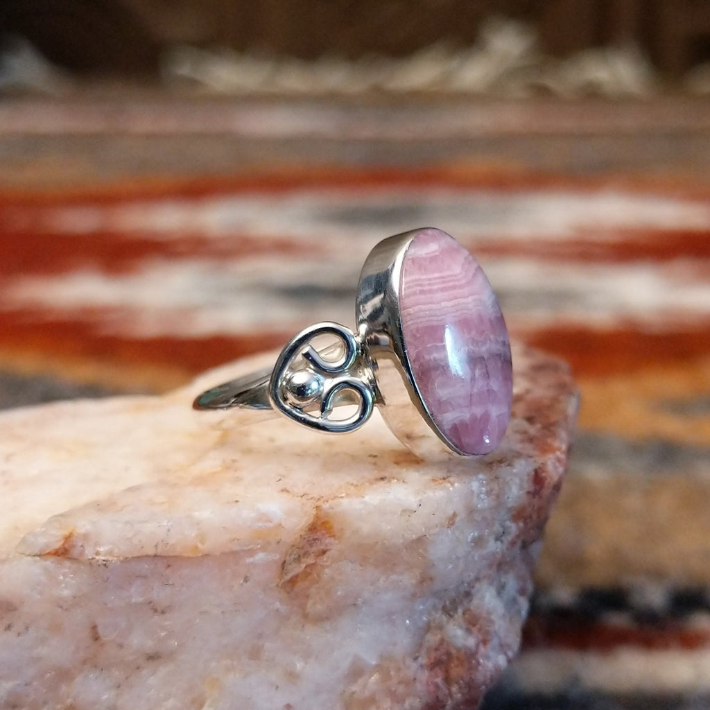 Sterling silver ring with ornate band and rhodochrosite set in the bezel.