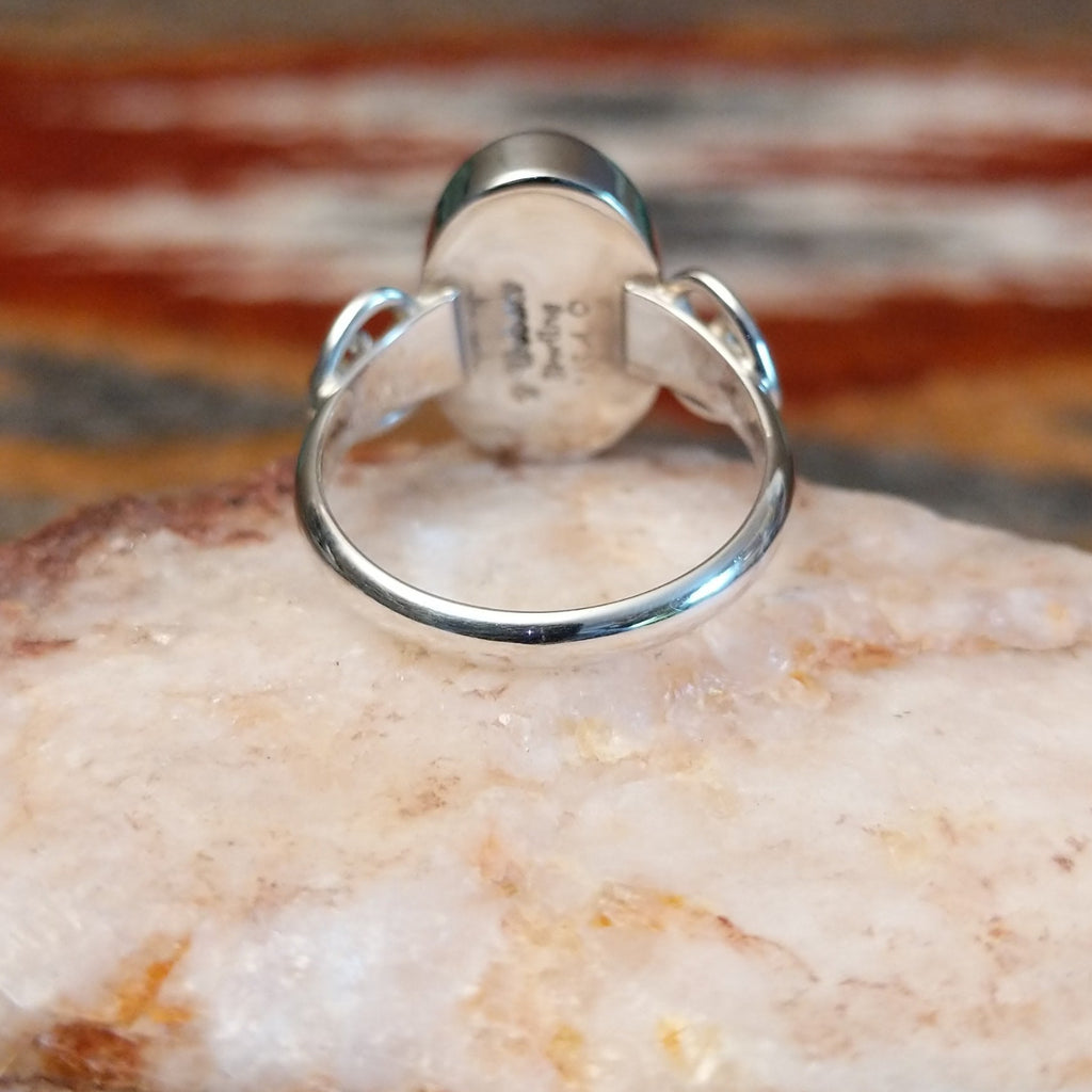 Sterling silver ring with ornate band and rhodochrosite set in the bezel.