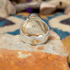 Sterling silver oval Turquoise inlay ring by Valerie Yazzie with geometric silver accents; underside view.