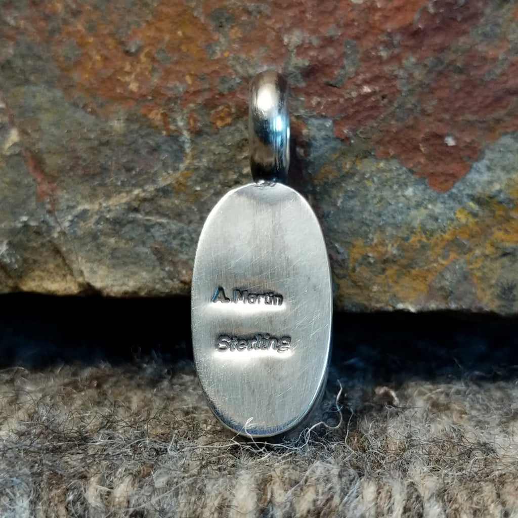 The backing features the artist's signature and stamp.