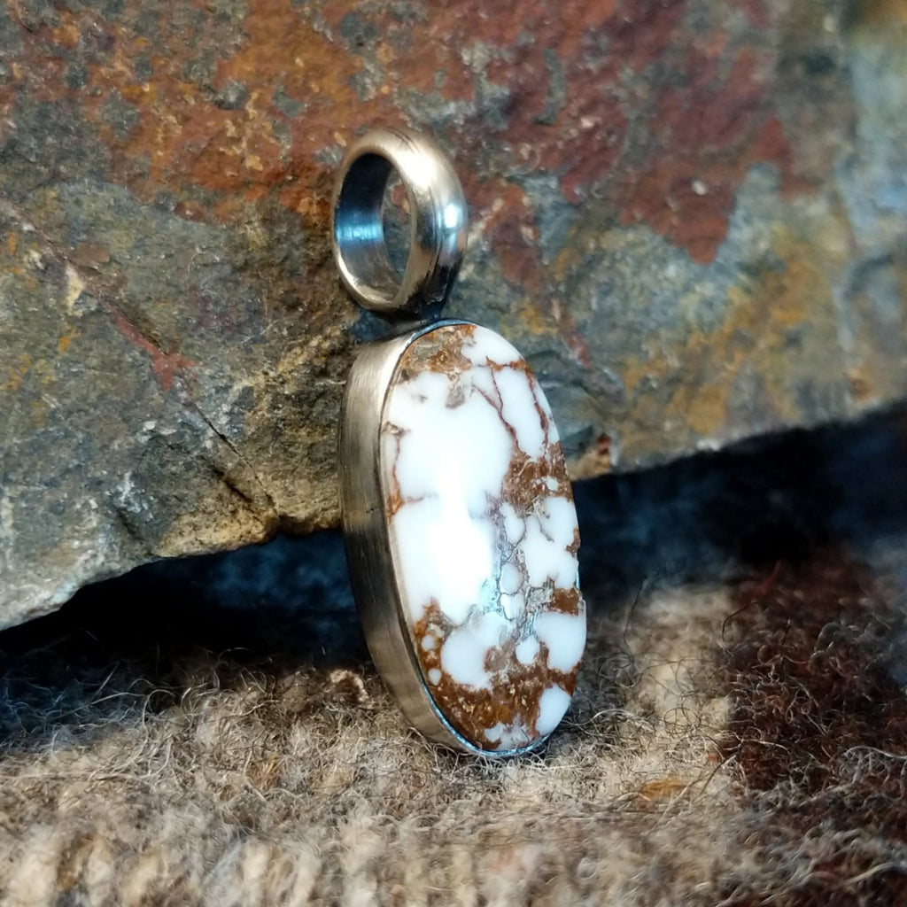 Wild horse stone in the shape of an oval set in the sterling silver bezel.